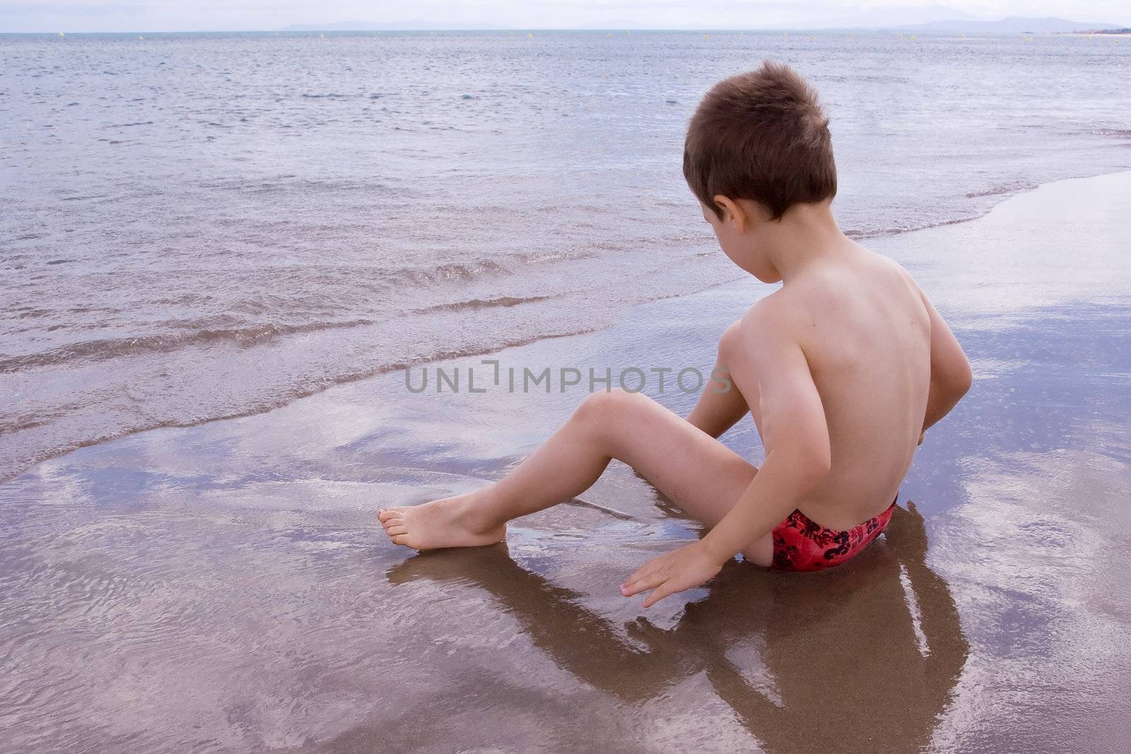 Young child alone on the beach by chrisroll