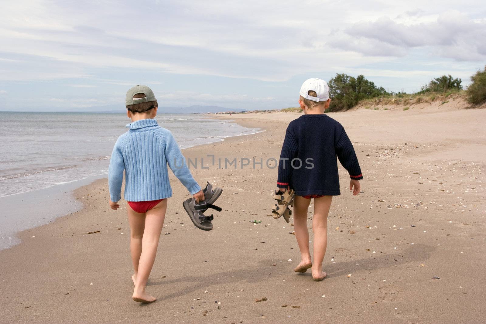 children walking on the beach by chrisroll