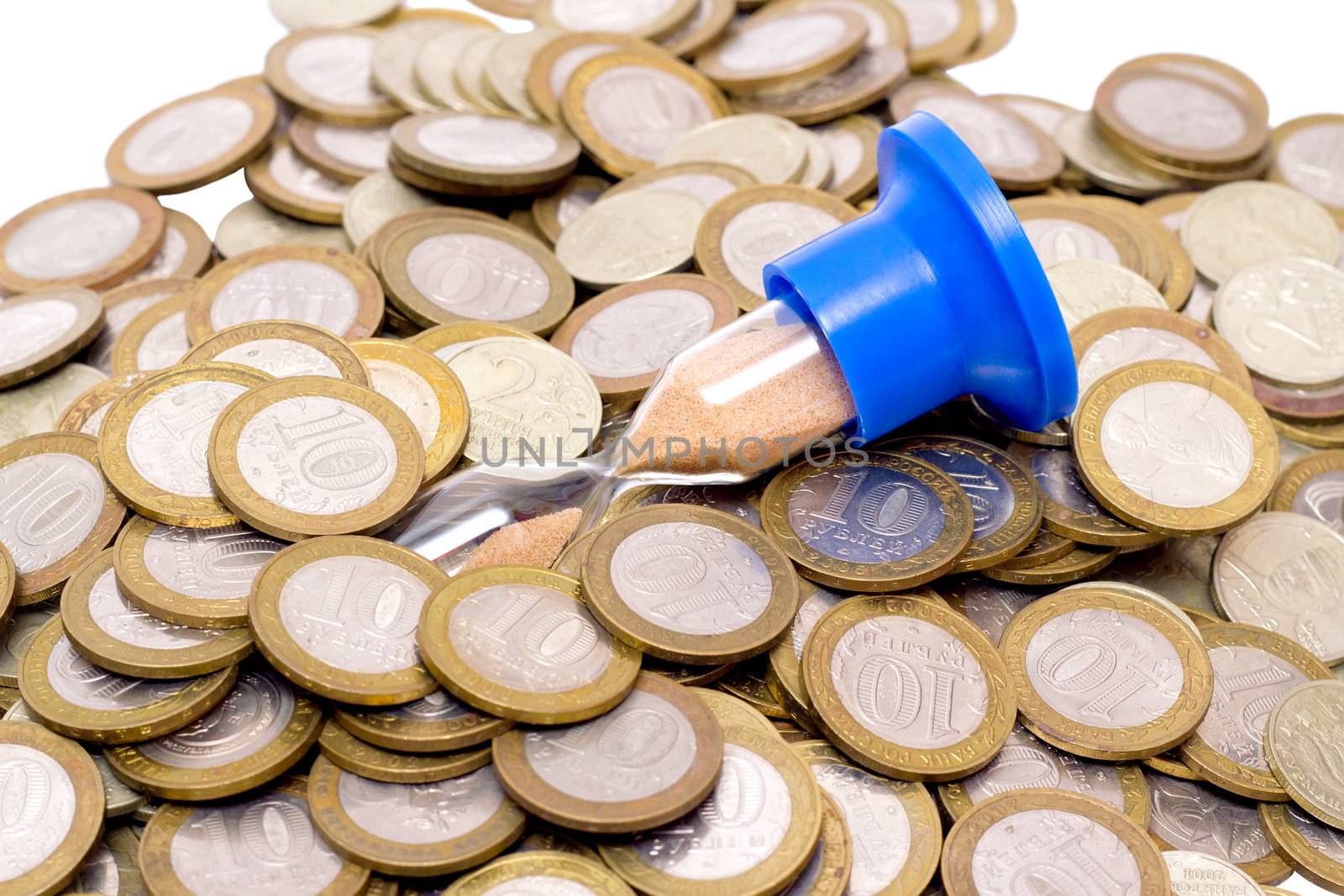 hourglass and a scattering of coins on white background