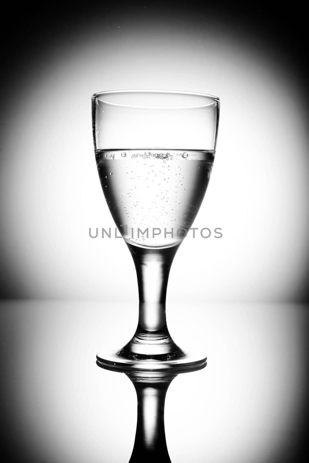 water glass on reflecting ground shimmering blue