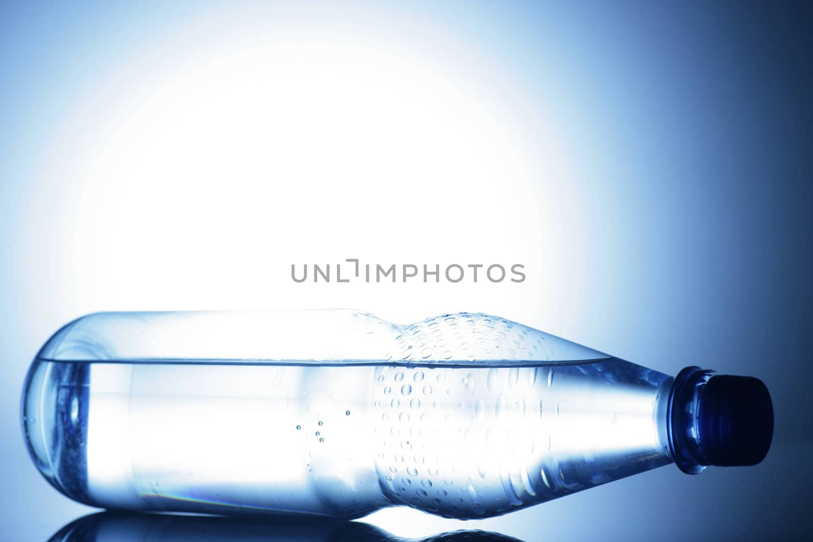 water bottle on a shiny surface in studio