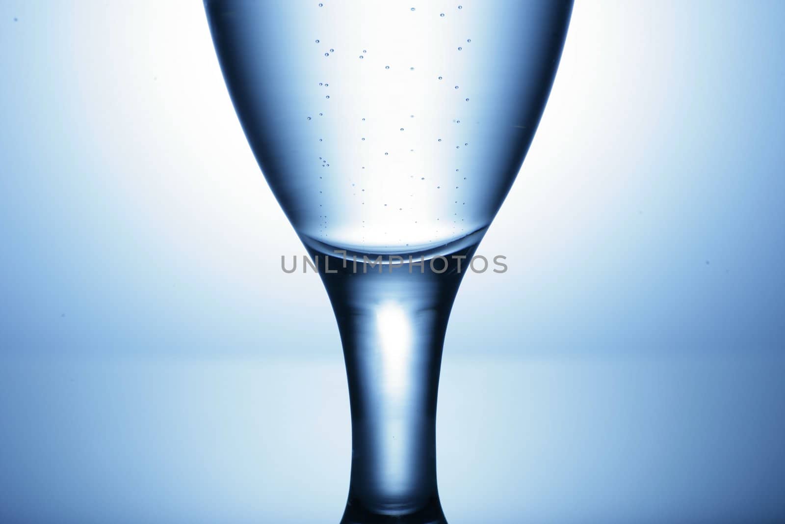 water glass on reflecting ground shimmering blue