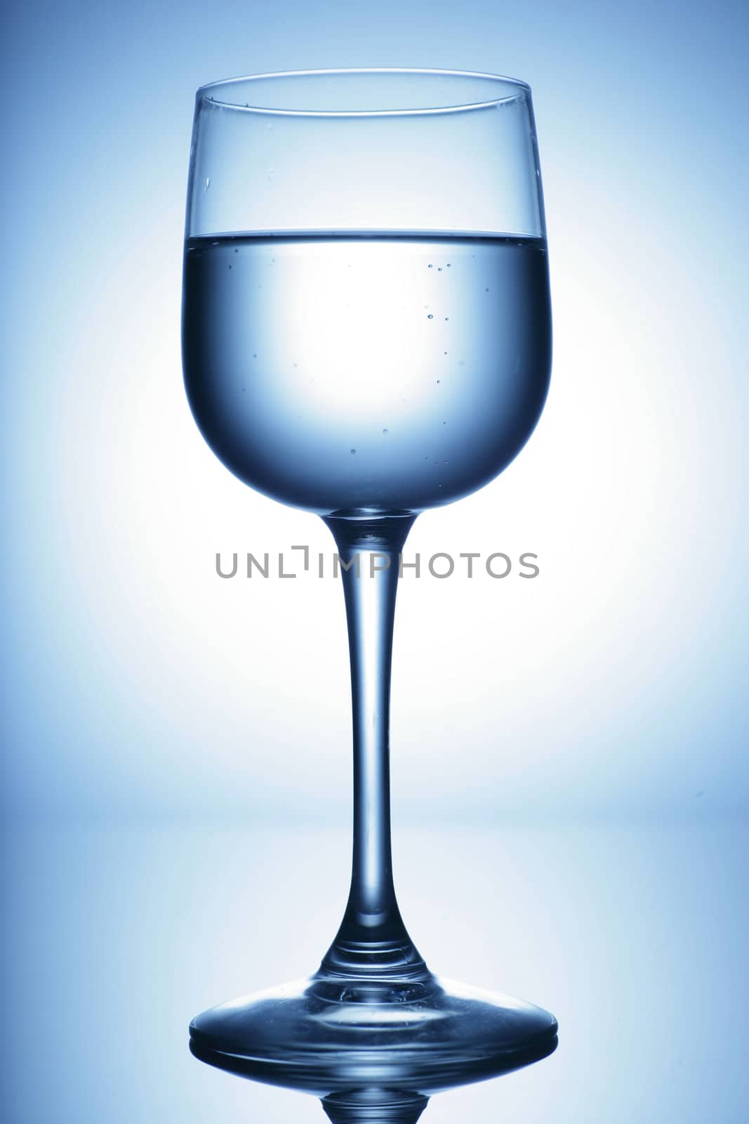 water glass on reflecting ground shimmering blue