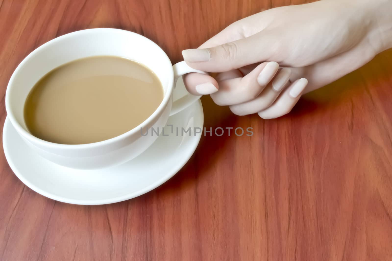 A woman holds a cup of coffee