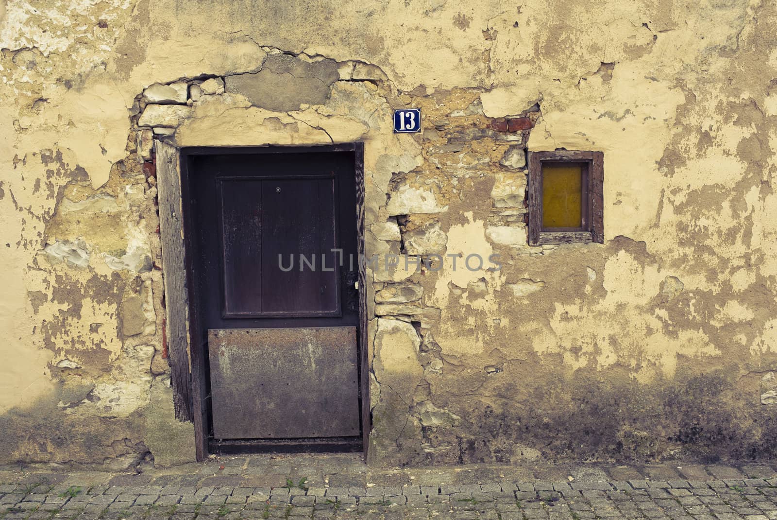 Entrance of an old abandoned house in a little German village. Cross processed to reflect time and age.