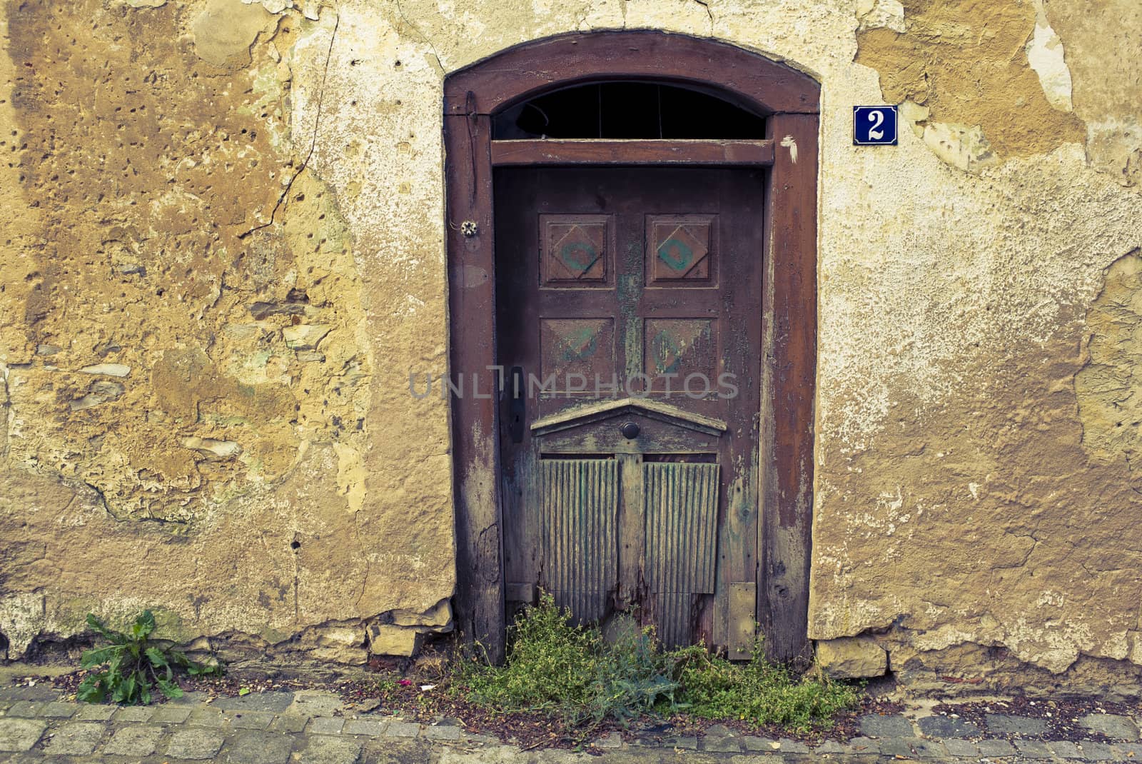 Beautiful old door of a bandoned house in a little German village. Cross processed to reflect time and age.