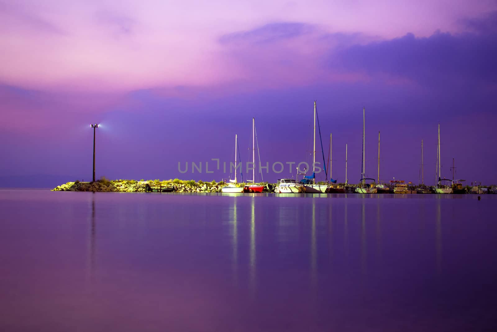 View of a yacht harbor at night. Long exposure shot by vician