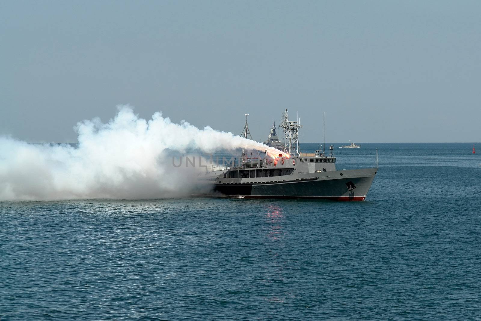 Fire by the military ship in the high sea