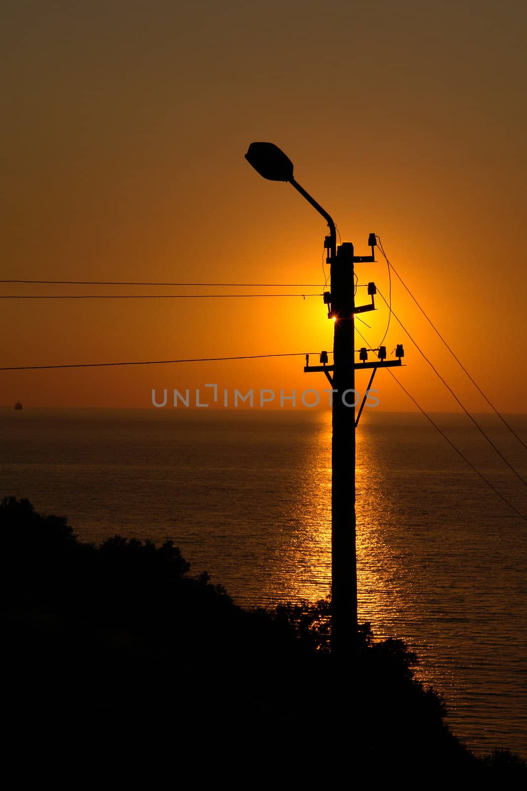 Silhouette of a street lantern on a sunset                              