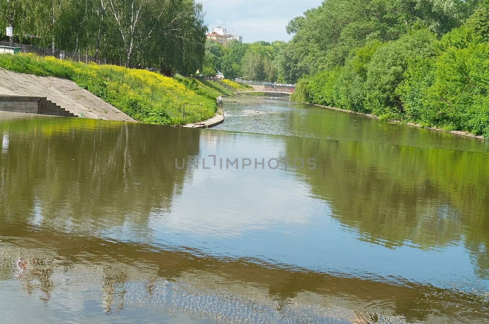 Overflow dam on small small river in city