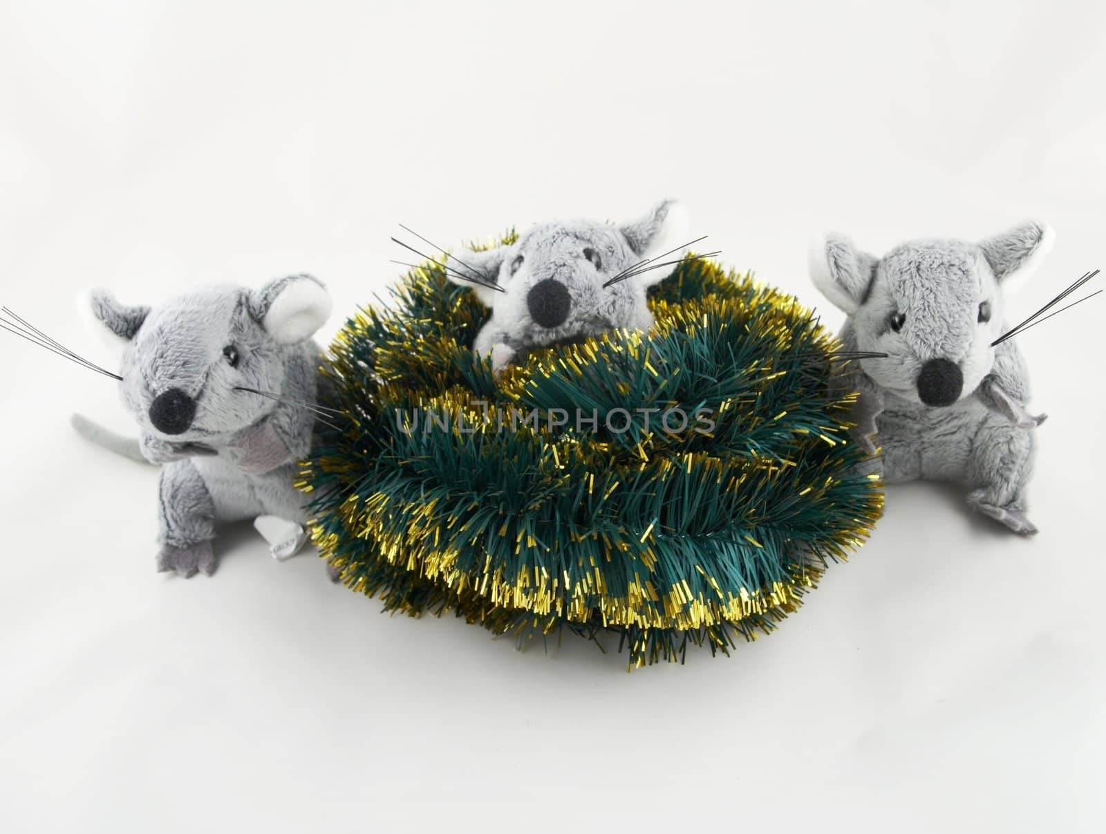 The grey toy mouse sitting in a tinsel