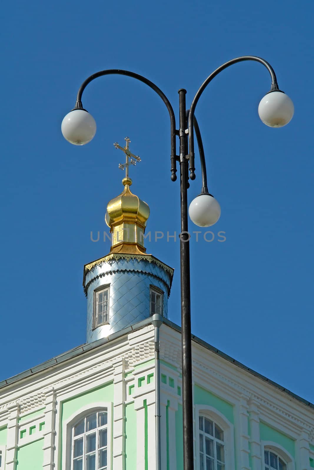 Street lamp and dome-shaped roof of an orthodox temple                               