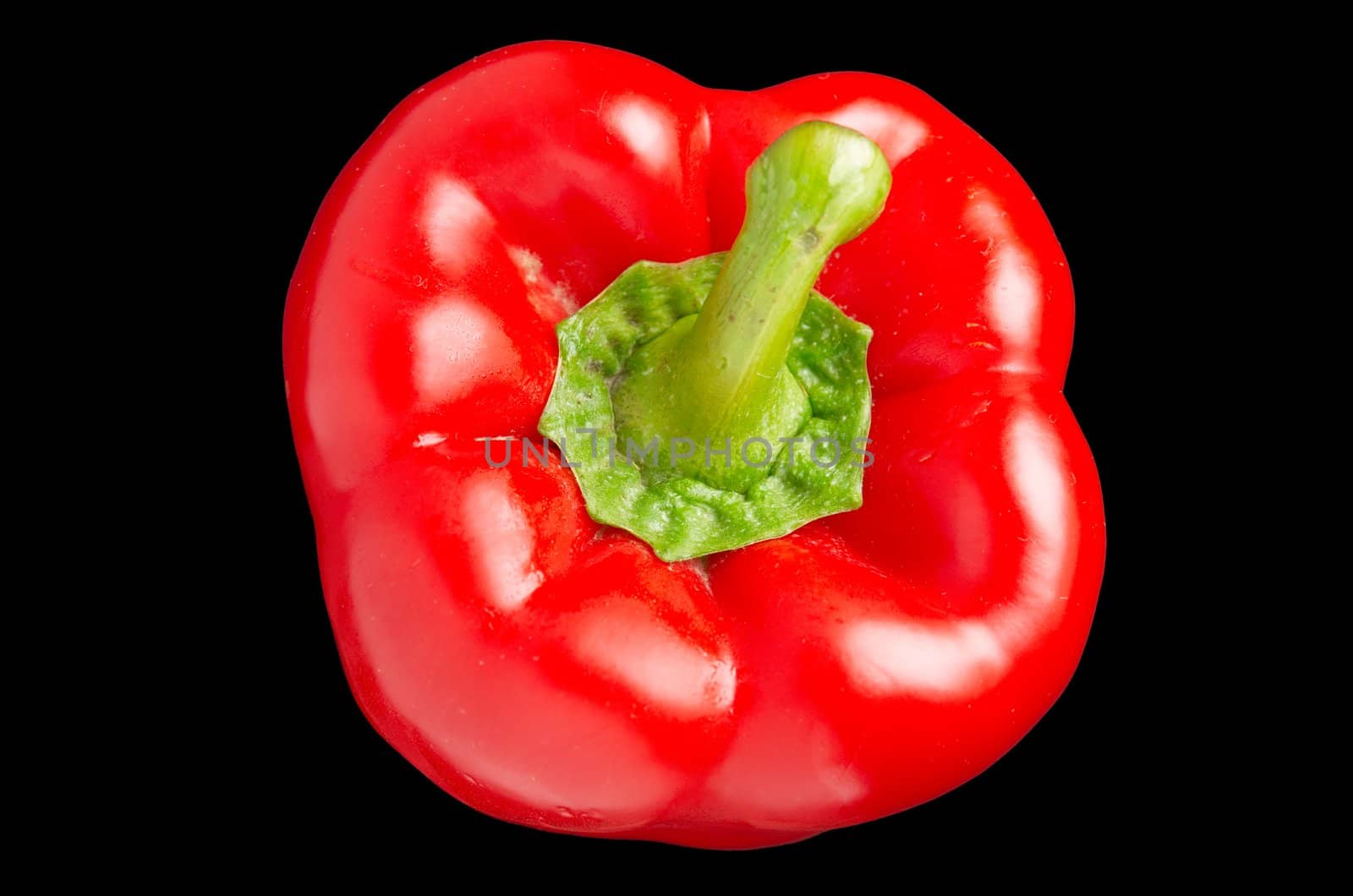 Red sweet pepper with a green cutting on a black background