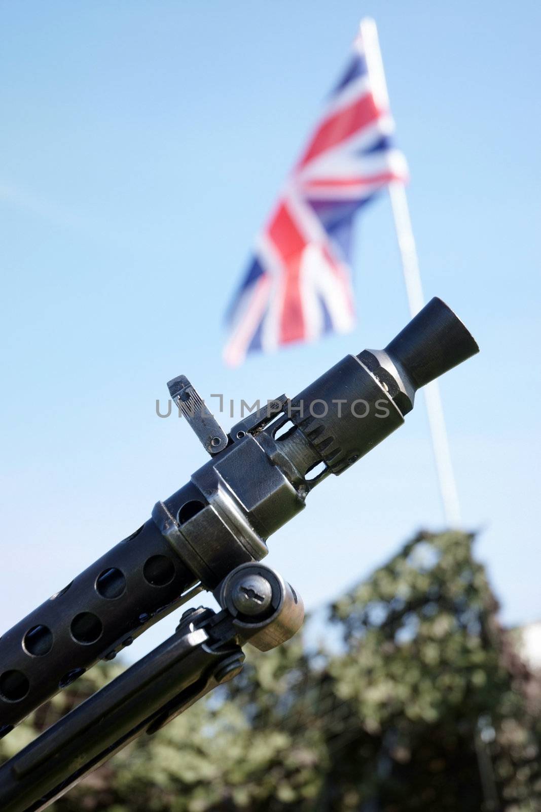Machine gun used in the Second World War with the Union Jack flag in background