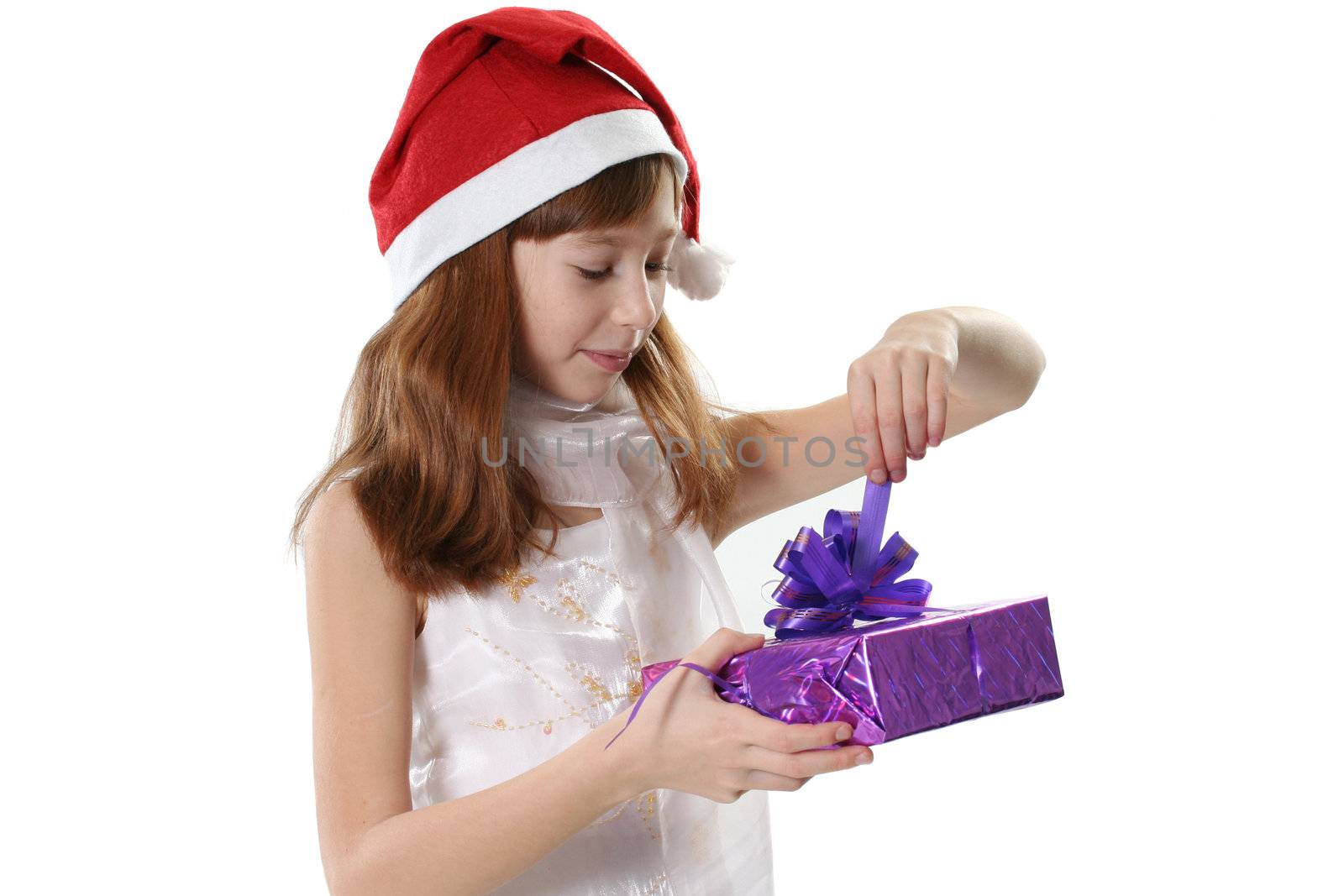 The girl in a white dress and a red hat, holds gifts in hands