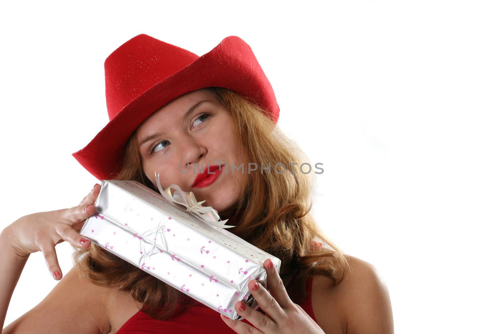 Portrait of the girl in a red hat and with a gift
