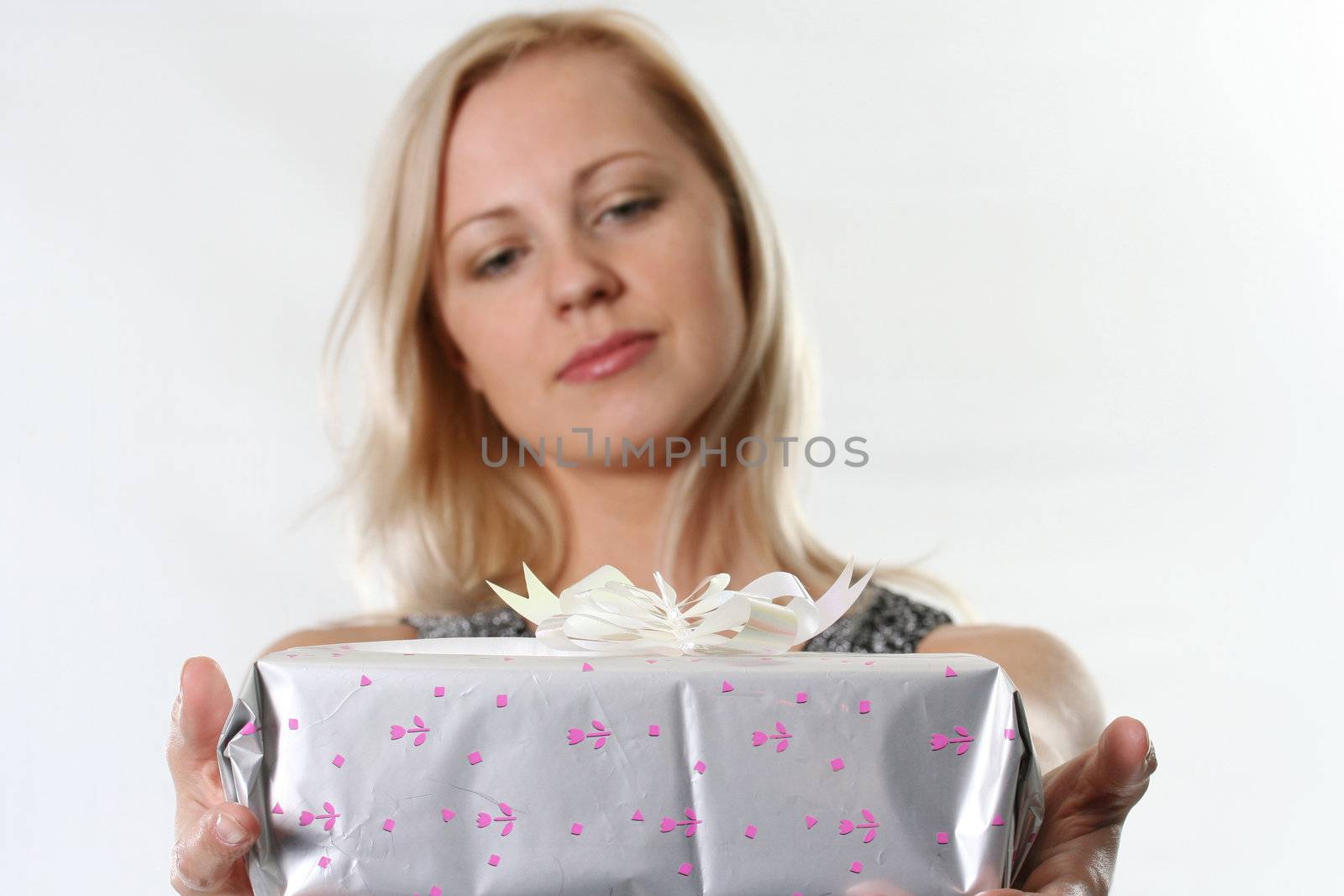 The young woman holds a gift before itself