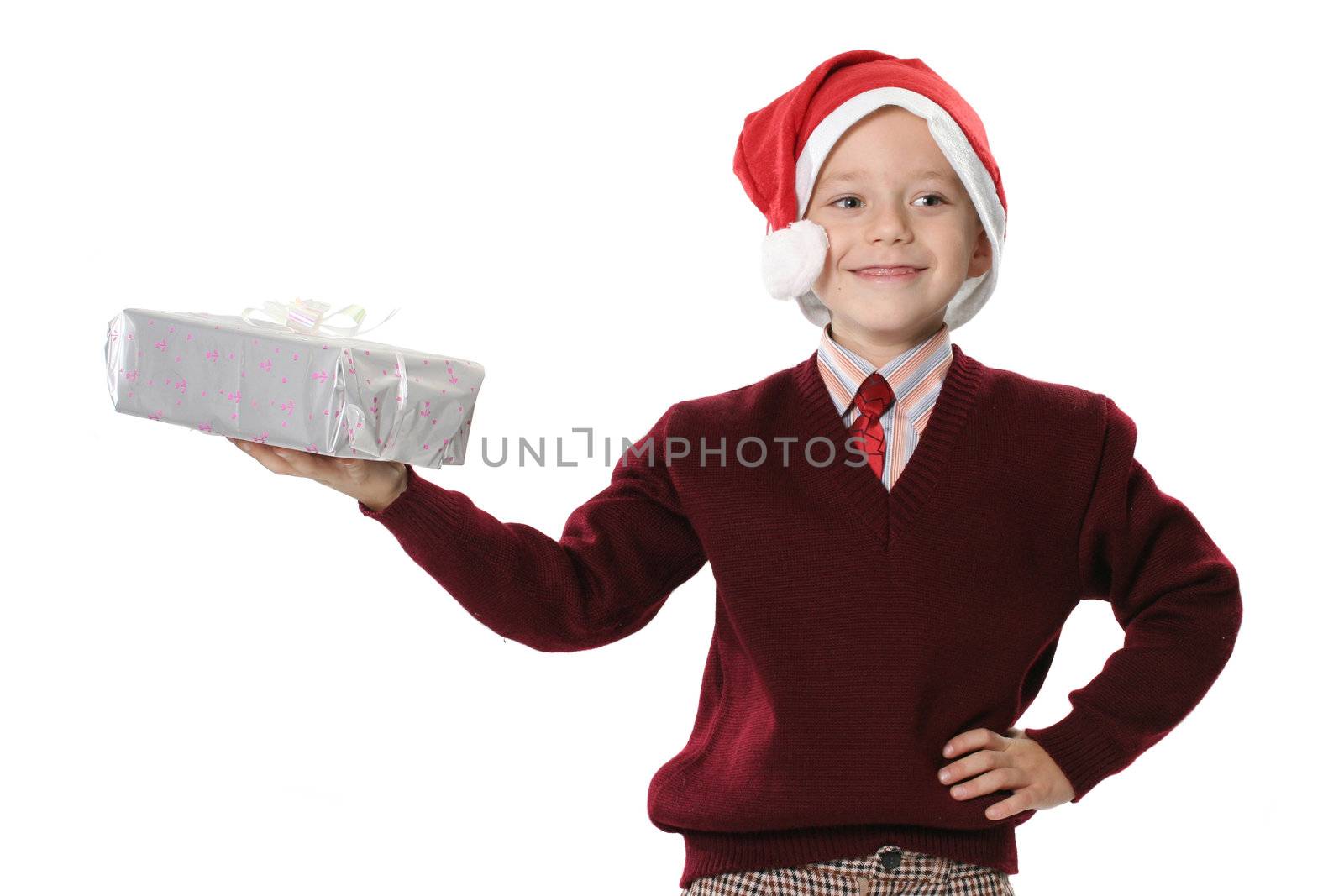 The boy in a sweater and cap Santa holds gift
