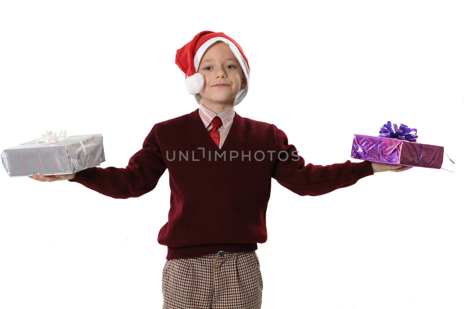  The boy in a sweater and cap Santa holds two gifts