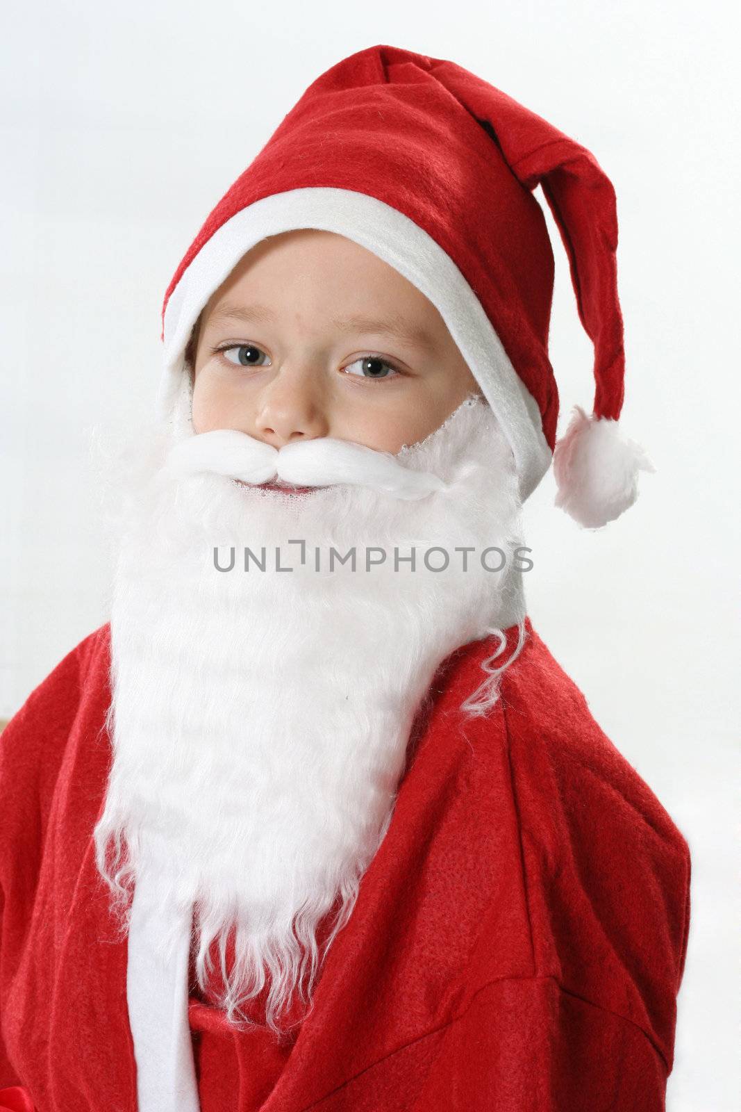 Portrait of a boy in cap Santa and white beard