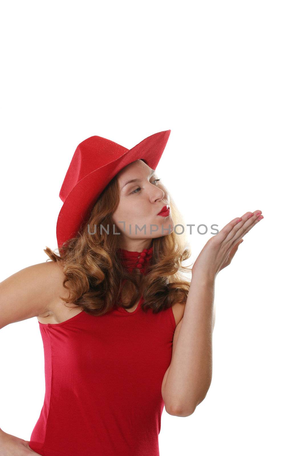 The girl in a red dress and a hat gives an air kiss