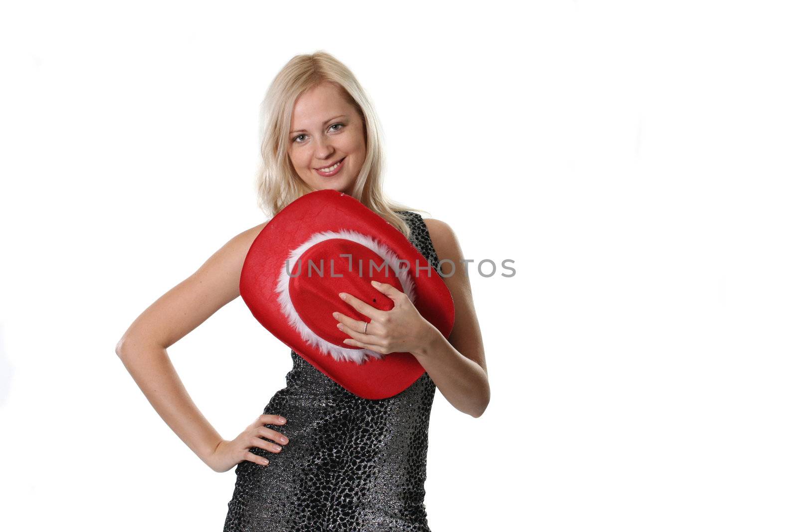 The beautiful young woman holds a red hat in a hand