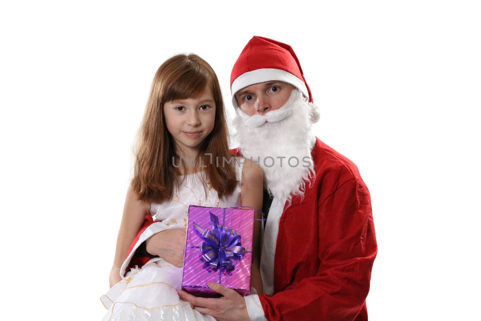Santa poses with the girl and a gift on a white background