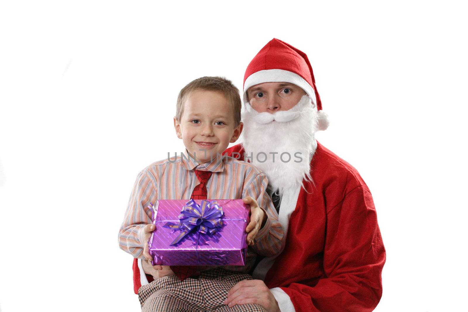 Santa poses with the little boy and a gift on a white background
