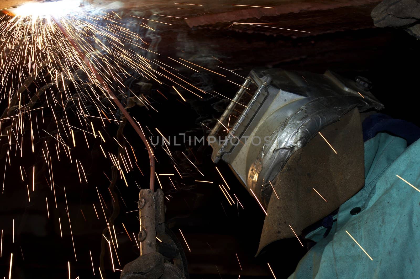 a welder working at shipyard under vessel