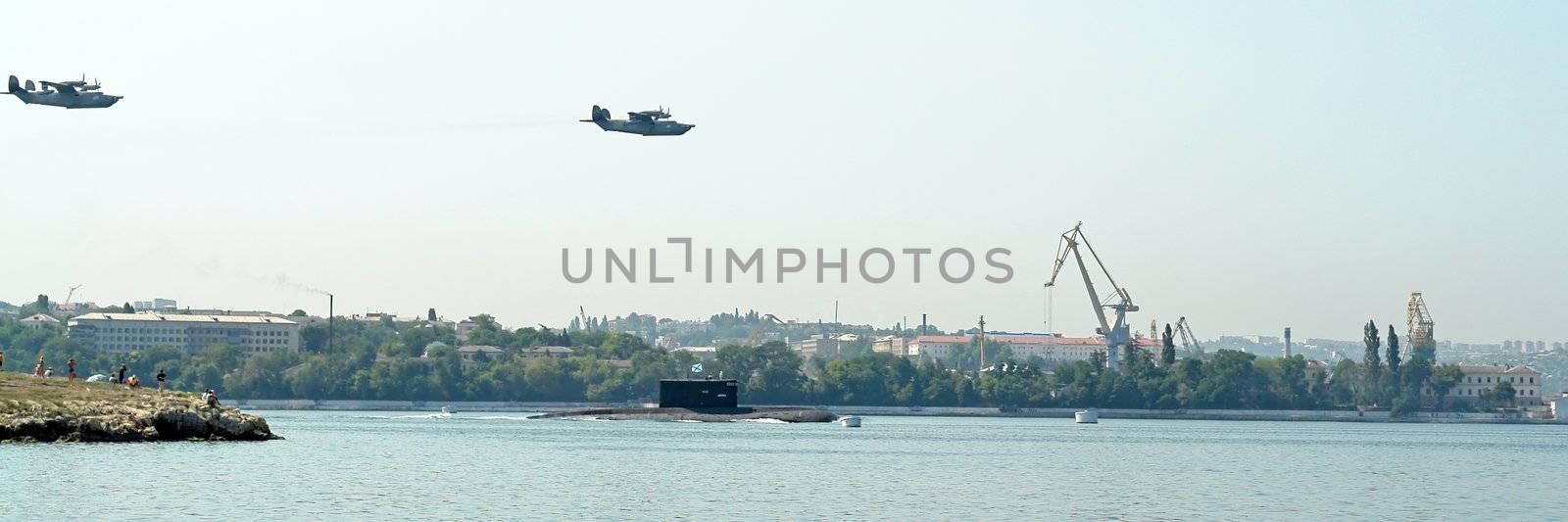 Military planes fly by above a submarine by stepanov