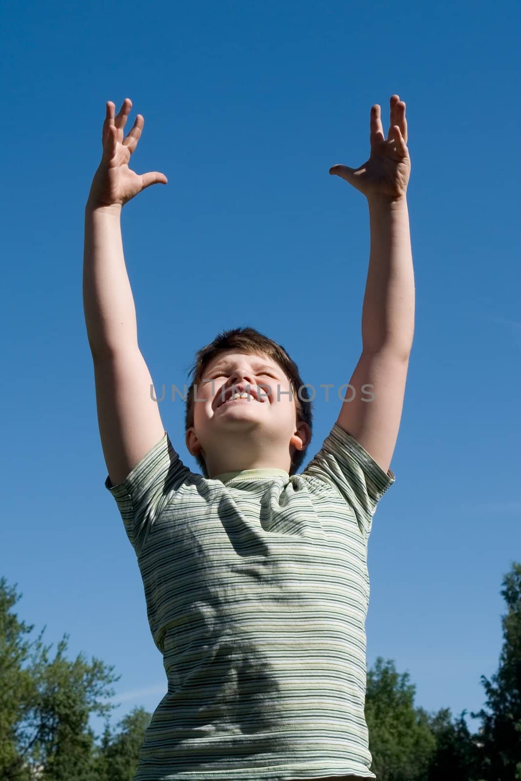 A little boy with sky at background 