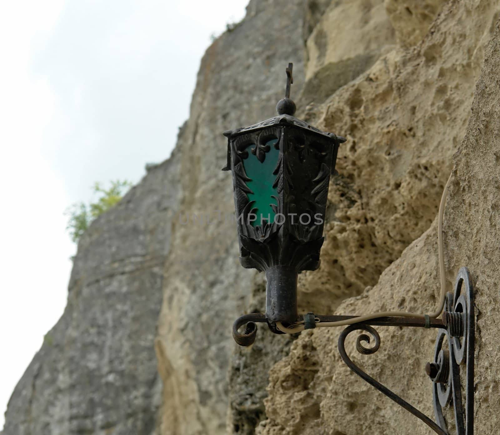 Street lantern with rock  at background