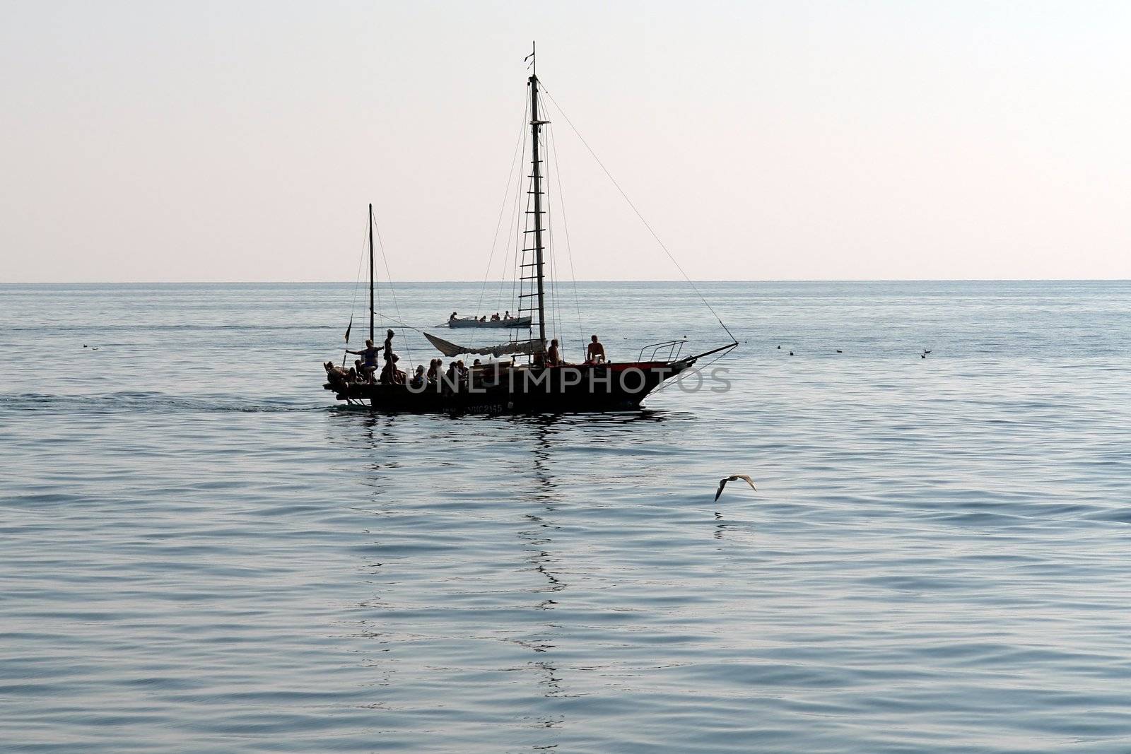 Small yacht with sea waves at background