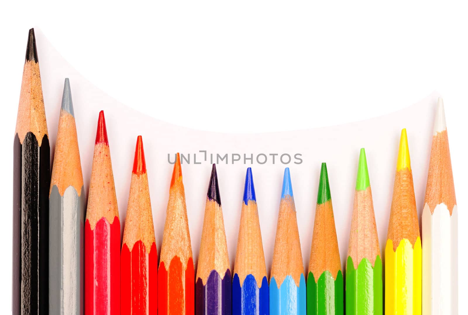A curved row of coloured pencils on a white background.