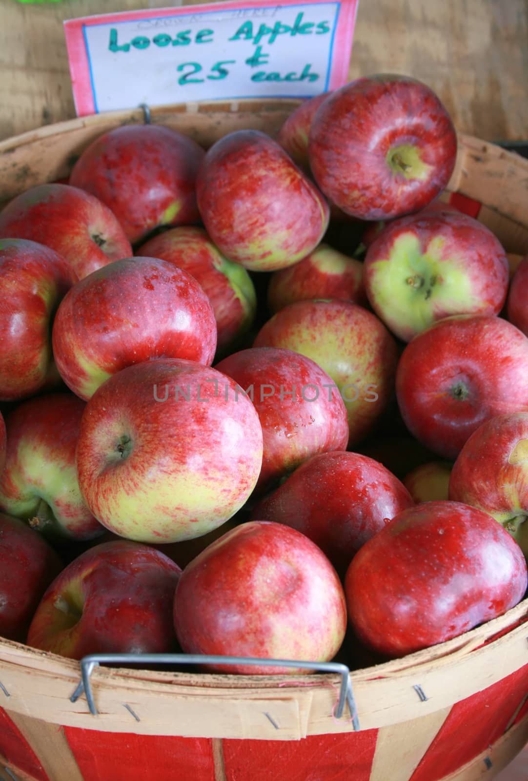a bushel basket of just-harvested apples for sale