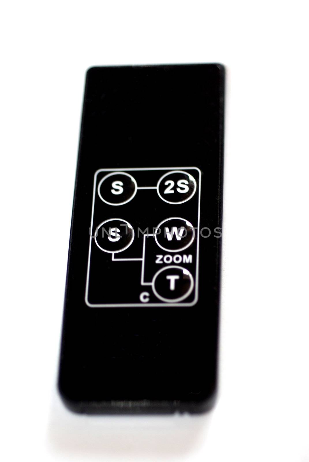 A close up photograph of a generic camera remote control