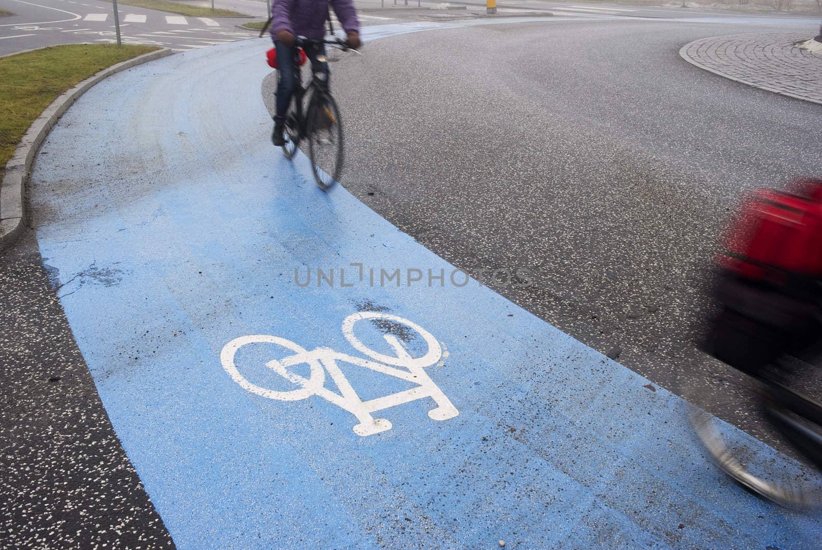 Two busy cyclist passing by on their way to job in the winter morning - Denmark. Motion blur.