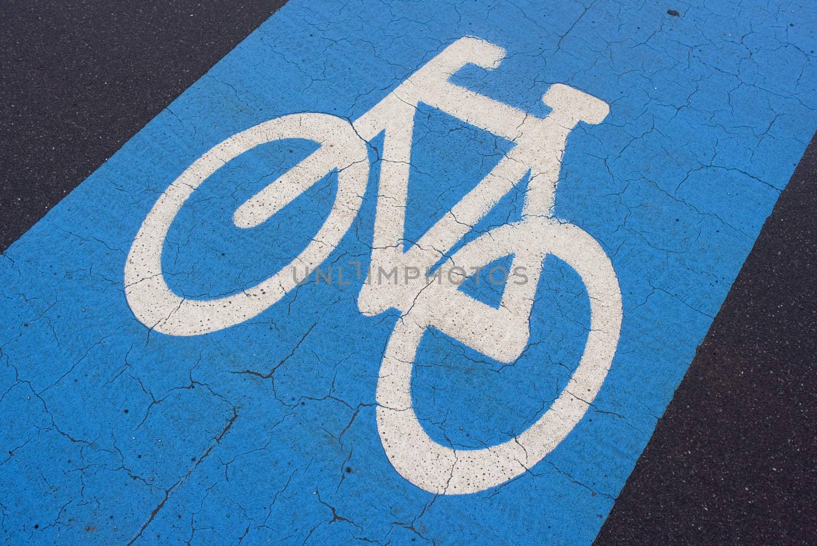 Weathered blue urban bicycle lane with space for text.