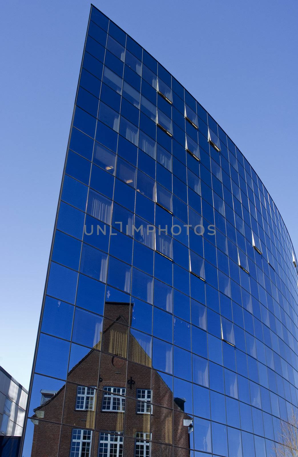 Futuristic public hospital building with reflection of old hospital building.