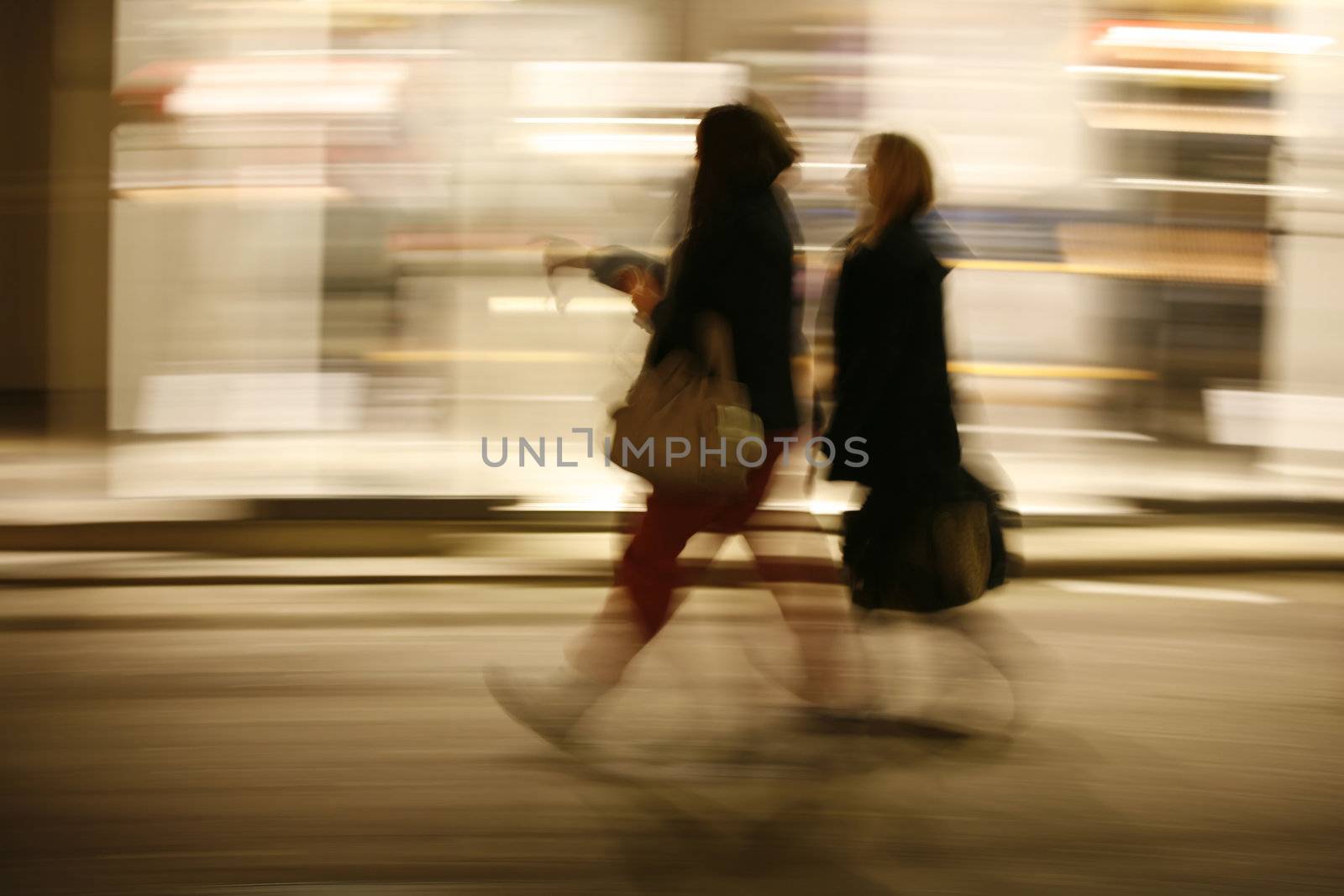Power shopping after dark. Motion blur.