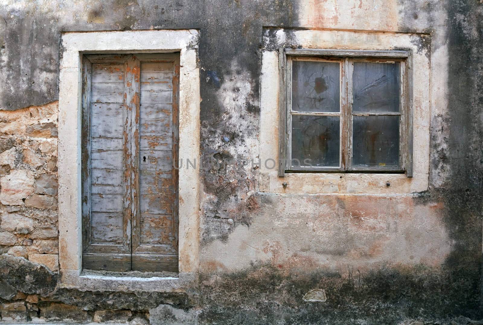 Window and entrance of abandoned house Croatia.