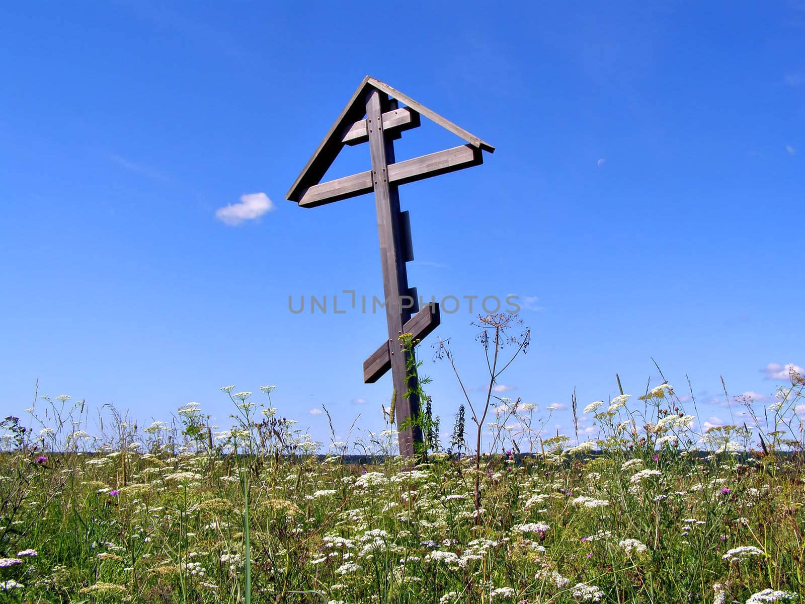 solitary grave cross on field