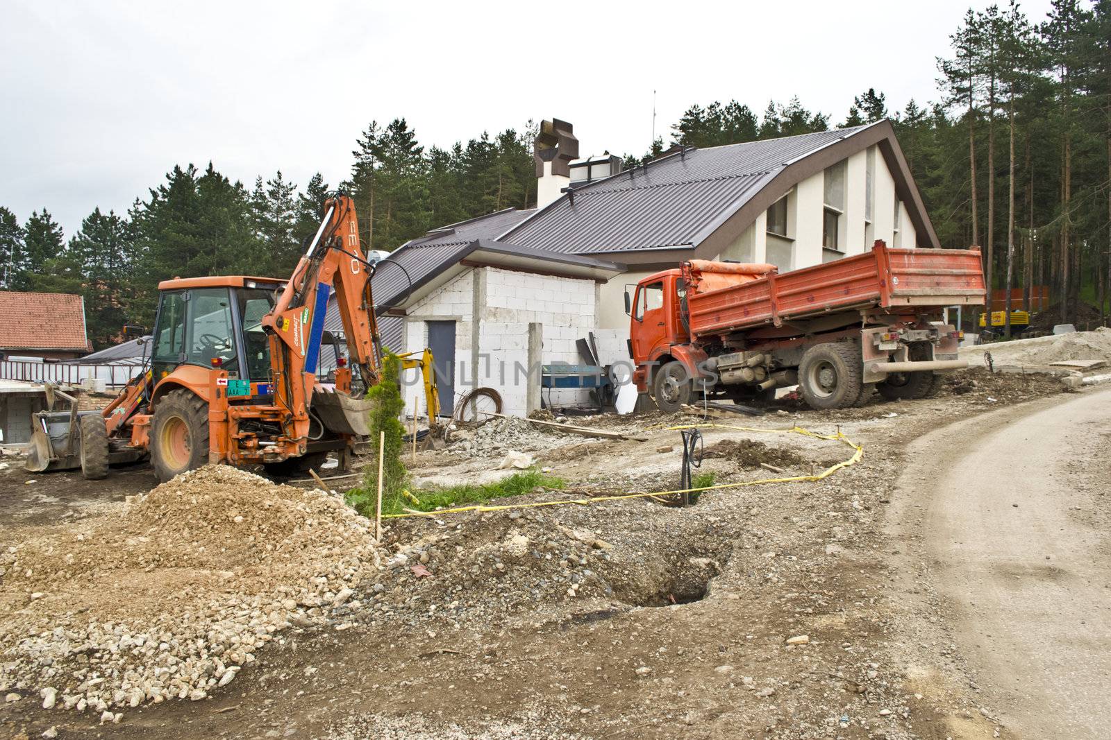 Excavator on site working,road repair,building house by vician