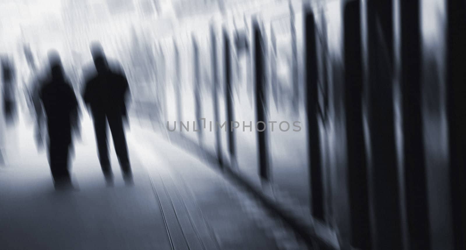 Commuters at the platform waiting for departure of the train. Filmgrain added to give some atmosphere.