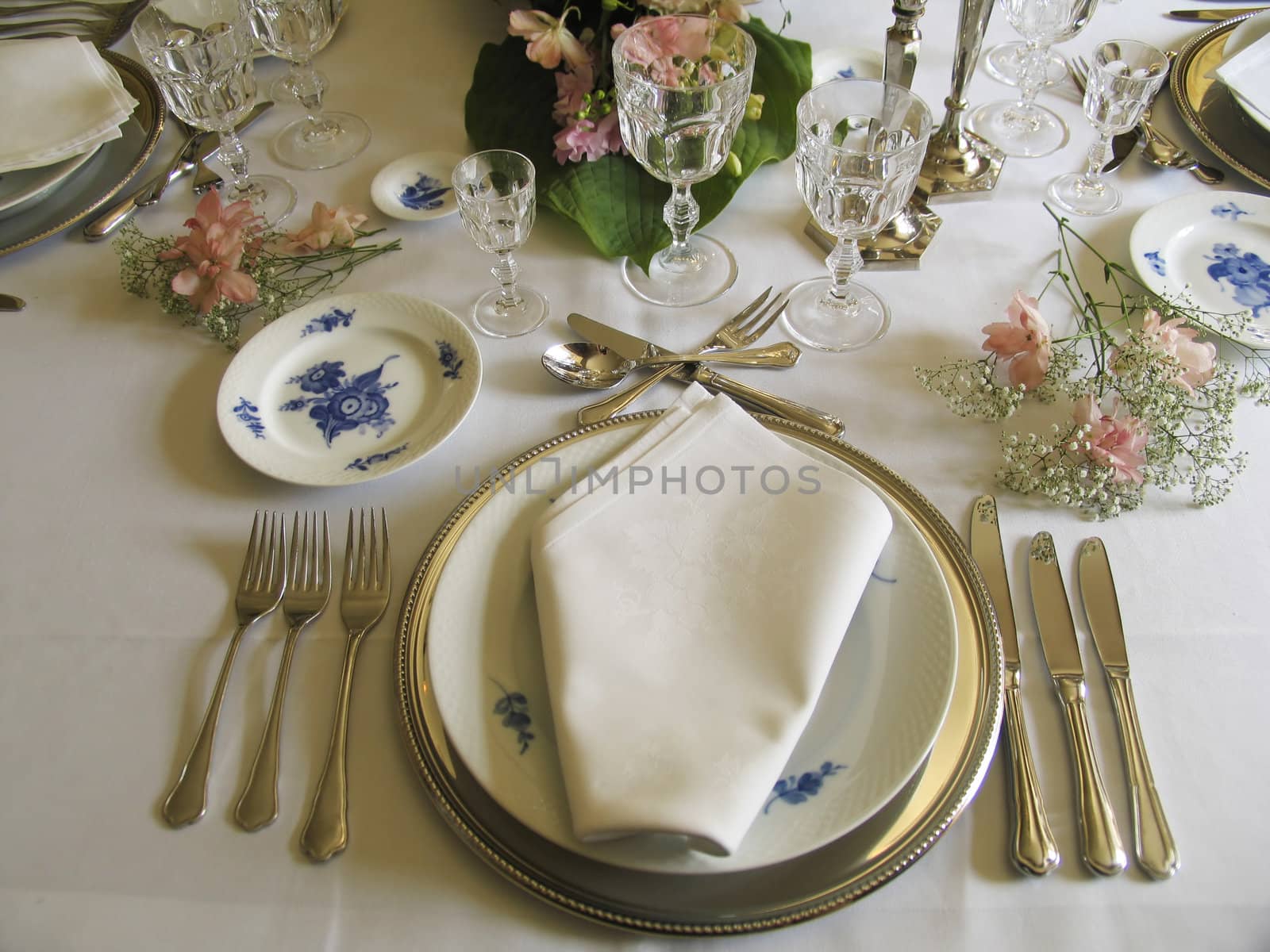 A beautiful laid dinnertable in retro style with very old silver, glasses and porcelain.