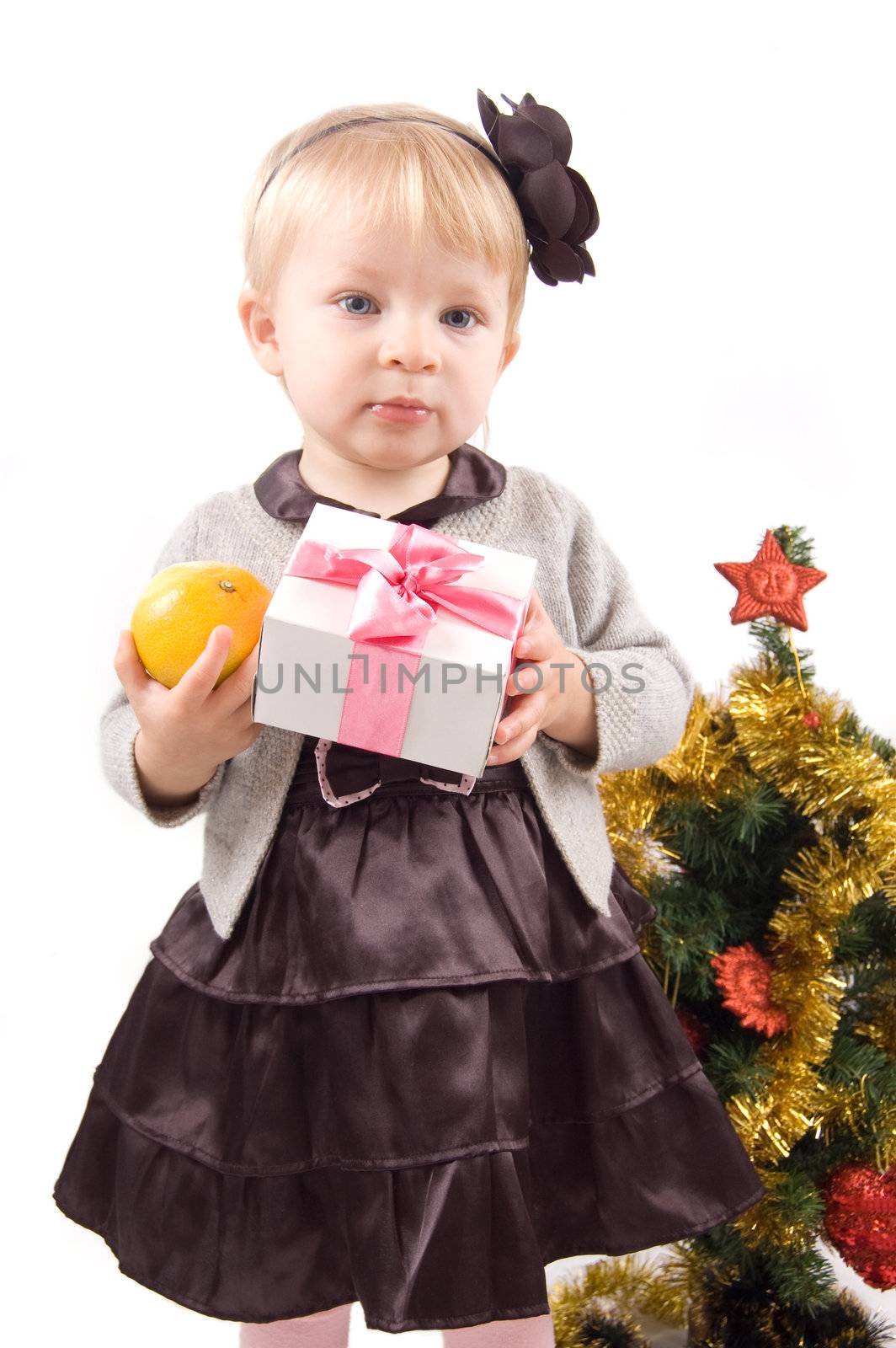 Cute little girl with Christmas tree and gifts over white