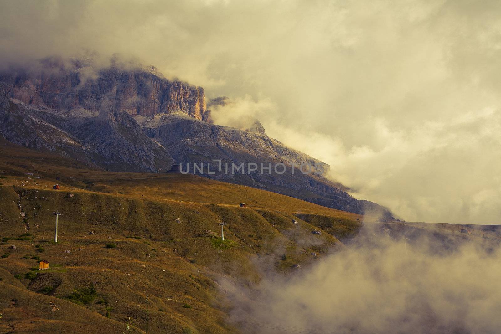 Early September morning with low hanging clouds in the Dolomites. Image is cross processed and a little film grain added to reflect age.