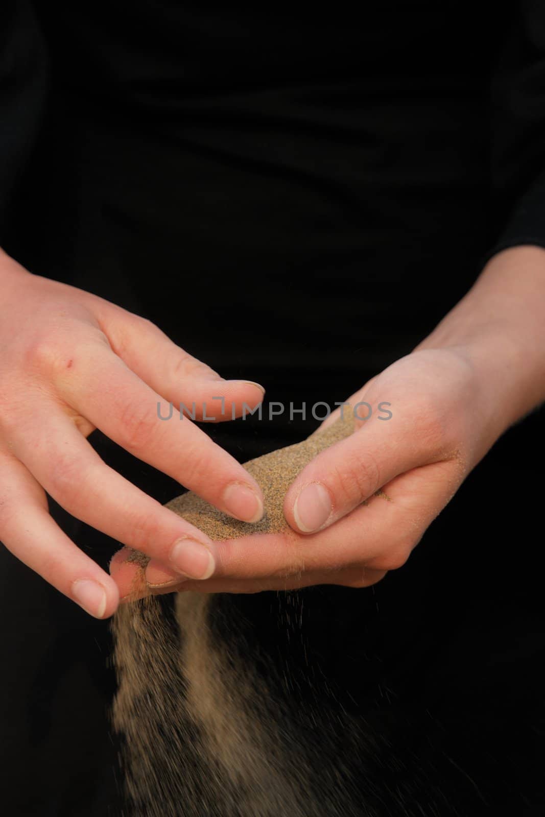 sand running through hands as a symbol for time running, lost etc.............