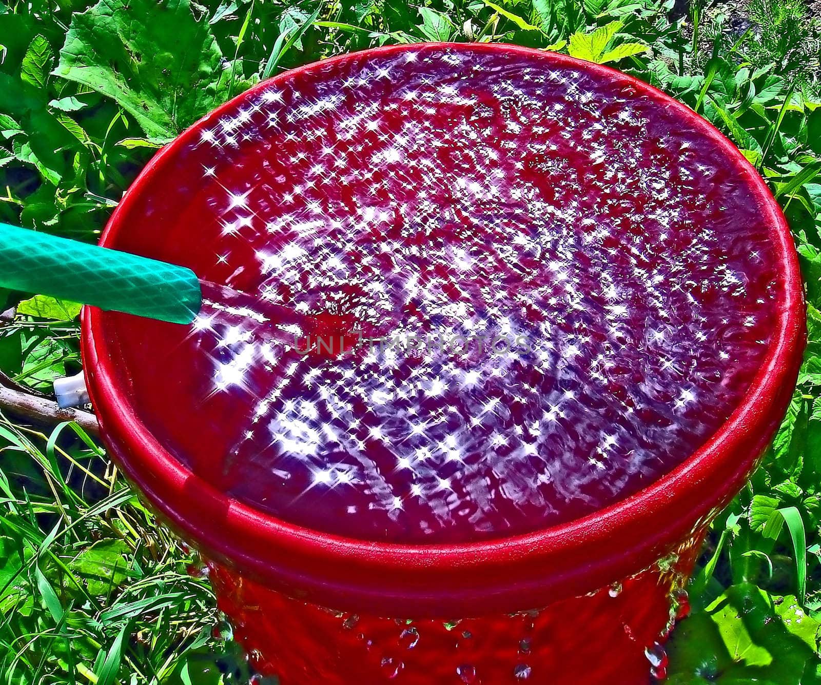 streem of water in red pail