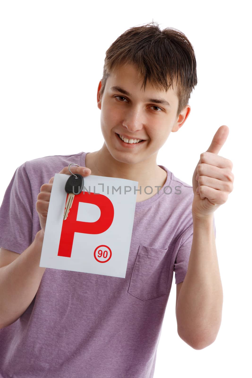 A happy male teen holds a red P plate and car key with thumbs up success sign.  White background.
